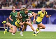 29 July 2024; Béibhinn Parsons of Team Ireland is tackled by Isabella Nasser of Team Australia during the Women's Rugby Sevens quarter-final match between Team Ireland and Team Australia at the Stade de France during the 2024 Paris Summer Olympic Games in Paris, France. Photo by David Fitzgerald/Sportsfile