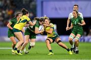 29 July 2024; Eve Higgins of Team Ireland is tackled by Kahli Henwood, left, and Bridget Clark of Team Australia during the Women's Rugby Sevens quarter-final match between Team Ireland and Team Australia at the Stade de France during the 2024 Paris Summer Olympic Games in Paris, France. Photo by David Fitzgerald/Sportsfile