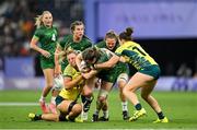 29 July 2024; Eve Higgins of Team Ireland is tackled by Kahli Henwood, right, and Bridget Clark of Team Australia during the Women's Rugby Sevens quarter-final match between Team Ireland and Team Australia at the Stade de France during the 2024 Paris Summer Olympic Games in Paris, France. Photo by David Fitzgerald/Sportsfile