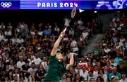 31 July 2024; Nhat Nguyen of Team Ireland in action against Victor Axelsen of Team Denmark during the men's singles group P match at the Porte de la Chapelle Arena during the 2024 Paris Summer Olympic Games in Paris, France. Photo by Stephen McCarthy/Sportsfile