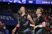 31 July 2024; Anders Skaarup Rasmussen, left, and Kim Astrup of Team Denmark celebrate winning against Takuro Hoki and Yugo Kobayashi of Team Japan in the men's singles group P match at the Porte de la Chapelle Arena during the 2024 Paris Summer Olympic Games in Paris, France. Photo by Stephen McCarthy/Sportsfile
