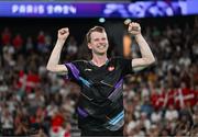 31 July 2024; Kim Astrup of Team Denmark celebrates winning with team mate Anders Skaarup Rasmussen, not pictured, against Takuro Hoki and Yugo Kobayashi of Team Japan in the men's singles group P match at the Porte de la Chapelle Arena during the 2024 Paris Summer Olympic Games in Paris, France. Photo by Stephen McCarthy/Sportsfile