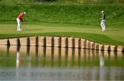 1 August 2024; Scottie Schefler of Team USA putts on the first green watched by Rory McIlroy of Team Ireland during round 1 of the men's golf singles at Le Golf National during the 2024 Paris Summer Olympic Games in Paris, France. Photo by Brendan Moran/Sportsfile