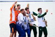 1 August 2024; Men's double sculls A bronze medallists Daire Lynch, right, and Philip Doyle of Team Ireland take a photo with gold medallists Andrei Sabastian Cornea and Marian Florian Enache of Team Romania and silver medallists Stef Broenink and Melvin Twellaar of Team Netherlands during the awards ceremony at Vaires-sur-Marne Nautical Stadium during the 2024 Paris Summer Olympic Games in Paris, France. Photo by Stephen McCarthy/Sportsfile