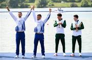 1 August 2024; From left, Men's double sculls A gold medallists Marian Florian Enache and Andrei Sabastian Cornea of Team Romania and bronze medallists Philip Doyle and Daire Lynch of Team Ireland during the awards ceremony at Vaires-sur-Marne Nautical Stadium during the 2024 Paris Summer Olympic Games in Paris, France. Photo by Stephen McCarthy/Sportsfile