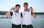 1 August 2024; Philip Doyle, right, and Daire Lynch of Team Ireland celebrate with their bronze medals after the men's double sculls A final at Vaires-sur-Marne Nautical Stadium during the 2024 Paris Summer Olympic Games in Paris, France. Photo by Stephen McCarthy/Sportsfile