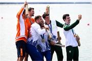 1 August 2024; Men's double sculls A bronze medallists Daire Lynch, right, and Philip Doyle of Team Ireland take a photo with gold medallists Andrei Sabastian Cornea and Marian Florian Enache of Team Romania and silver medallists Stef Broenink and Melvin Twellaar of Team Netherlands during the awards ceremony at Vaires-sur-Marne Nautical Stadium during the 2024 Paris Summer Olympic Games in Paris, France. Photo by Stephen McCarthy/Sportsfile
