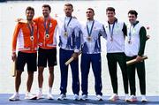 1 August 2024; From left, Men's double sculls A silver medallists Stef Broenik and Melvin Twellaar of Team Netherlands, gold medallists Marian Florian Enache and Andrei Sabastian Cornea of Team Romania and bronze medallists Philip Doyle and Daire Lynch of Team Ireland during the awards ceremony at Vaires-sur-Marne Nautical Stadium during the 2024 Paris Summer Olympic Games in Paris, France. Photo by Stephen McCarthy/Sportsfile