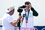 1 August 2024; Philip Doyle of Team Ireland speaks to Ruairi Mac Con Iomaire of TG4 after the men's double sculls A final at Vaires-sur-Marne Nautical Stadium during the 2024 Paris Summer Olympic Games in Paris, France. Photo by Stephen McCarthy/Sportsfile