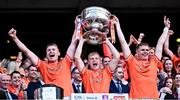 28 July 2024; Armagh players Rían O’Neill, left, Cian McConville and Oisín O’Neill, Cian is a cousin of the O’Neill brothers, all lift the Sam Maguire Cup after the GAA Football All-Ireland Senior Championship Final match between Armagh and Galway at Croke Park in Dublin. Photo by Piaras Ó Mídheach/Sportsfile