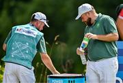 1 August 2024; Shane Lowry of Team Ireland and his caddie Darren Reynolds get fresh water during round 1 of the men's golf singles at Le Golf National during the 2024 Paris Summer Olympic Games in Paris, France. Photo by Brendan Moran/Sportsfile