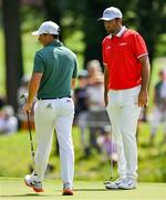 1 August 2024; Scottie Scheffler of Team USA, right, as Rory McIlroy of Team Ireland passes by during round 1 of the men's golf singles at Le Golf National during the 2024 Paris Summer Olympic Games in Paris, France. Photo by Brendan Moran/Sportsfile