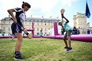1 August 2024; Lewis Judith practices his hurling skills with Maud Pradella of Paris Gaels at Fesport Festival at the Cháteau de Vincennes during the 2024 Paris Summer Olympic Games in Paris, France. Photo by Sam Barnes/Sportsfile