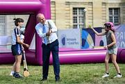 1 August 2024; Tánaiste, Minister for Foreign Affairs and Minister for Defence, Micheál Martin, TD, demonstrates his hurling skills at Fesport Festival at the Cháteau de Vincennes during the 2024 Paris Summer Olympic Games in Paris, France. Photo by Sam Barnes/Sportsfile