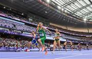 2 August 2024; Thomas Barr of Team Ireland takes the baton from Sophie Becker of Team Ireland during the 4x400m mixed relay round 1 at the Stade de France during the 2024 Paris Summer Olympic Games in Paris, France. Photo by Sam Barnes/Sportsfile