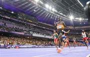 2 August 2024; Joshua Cheptegei of Team Uganda, centre, crosses the line to win gold in the men's 10,000m final setting a new Olympic record of 26:43.14 at the Stade de France during the 2024 Paris Summer Olympic Games in Paris, France. Photo by Sam Barnes/Sportsfile