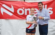 3 August 2024; Milltown, Kildare, captain Lisa Byrne is presented the Junior Championship cup by Uachtarán Cumann Peil Gael na mBan, Mícheál Naughton at the O’Neills All-Ireland Club 7s competitions at Naomh Mearnóg and St Sylvester’s GAA clubs in Dublin.  Photo by Ben McShane/Sportsfile