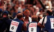 19 August 1998; Christine Arron of France is surrounded by photographers after her victory in the Women's 100m final during the European Athletics Championships at Nep Stadium in Budapest, Hungary. Photo by Brendan Moran/Sportsfile