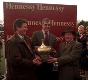 8 February 1998; Owner of Doran's Pride Tom Doran, left, and trainer Michael Hourigan, right, are presented the Hennessy Cognac Gold Cup by Maurice Hennessy during the horse racing from Leopardstown in Dublin. Photo by Matt Browne/Sportsfile