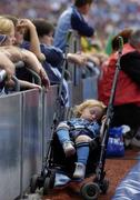 14 August 2004; Supporters from all sides watch the match as Dublin supporter Niamh Finnegan from Finglas sleeps near the sideline. Bank of Ireland Senior Football Championship Quarter-Final, Dublin v Kerry, Croke Park, Dublin. Picture credit; Damien Eagers / SPORTSFILE