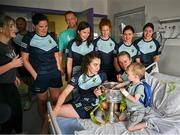 5 August 2024; Anna Maria O'Donoghue, Anna Galvin, Louise Ní Mhuircheartaigh, Cáit Lynch, Eilís Lynch Aisling O'Connor and Niamh Carmody from TG4 All-Ireland Ladies Senior Football Champions Kerry are pictured with the Brendan Martin Cup and three year old Dylan O'Sullivan with his mum Flora and dad Eoghan, from Glenbeigh, in Kerry, during a visit by the players to Children's Health Ireland at Crumlin, Dublin. Photo by Ray McManus/Sportsfile