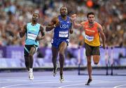 7 August 2024; Grant Holloway of Team USA, centre, crosses the finish line to win in the men's 110m hurdles semi-finals at the Stade de France during the 2024 Paris Summer Olympic Games in Paris, France. Photo by David Fitzgerald/Sportsfile