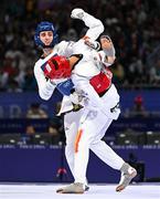 7 August 2024; Jack Woolley of Team Ireland, left, in action against Adrian Vincente Yunta of Team Spain during the men's -58kg Repechage at the Grand Palais during the 2024 Paris Summer Olympic Games in Paris, France. Photo by Stephen McCarthy/Sportsfile