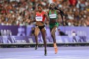 7 August 2024; Rhasidat Adeleke of Team Ireland, right, on her way to finishing second behind Salwa Eid Naser of Team Bahrain during the women's 400m semi-finals at the Stade de France during the 2024 Paris Summer Olympic Games in Paris, France. Photo by David Fitzgerald/Sportsfile