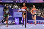 7 August 2024; Salwa Eid Naser of Team Bahrain, centre, crosses the finish line to finish win in the women's 400m semi-finals at the Stade de France during the 2024 Paris Summer Olympic Games in Paris, France. Photo by Sam Barnes/Sportsfile