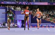 7 August 2024; Salwa Eid Naser of Team Bahrain, centre, crosses the finish line to finish win in the women's 400m semi-finals at the Stade de France during the 2024 Paris Summer Olympic Games in Paris, France. Photo by Sam Barnes/Sportsfile