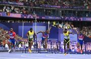 8 August 2024; Grant Holloway of Team United States, centre, dips for the line to win gold in the men's 110m hurdles finalat the Stade de France during the 2024 Paris Summer Olympic Games in Paris, France. Photo by Sam Barnes/Sportsfile
