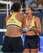 8 August 2024; Duda Lisboa, right, and Ana Patrícia of Team Brazil celebrate after the women's beach volleyball semi final match between Team Brazil and Team Australia at the Eiffel Tower Stadium during the 2024 Paris Summer Olympic Games in Paris, France. Photo by David Fitzgerald/Sportsfile