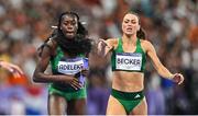 10 August 2024; Rhasidat Adeleke receives the baton from Team Ireland teammate Sophie Becker during the women's 4x400 relay final at the Stade de France during the 2024 Paris Summer Olympic Games in Paris, France. Photo by Sam Barnes/Sportsfile