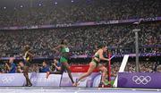 10 August 2024; Phil Healy of Team Ireland receives the baton from Rhasidat Adeleke during the women's 4x400 relay final at the Stade de France during the 2024 Paris Summer Olympic Games in Paris, France. Photo by Sam Barnes/Sportsfile