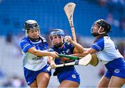 11 August 2024; Emma Flanagan of Tipperary in action against Laura Finlay, left, and Fiona Scully of Laois during the All-Ireland Premier Junior Camogie Championship final between Laois and Tipperary at Croke Park in Dublin. Photo by Piaras Ó Mídheach/Sportsfile