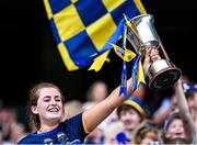 11 August 2024; Tipperary captain Sinéad Meagher lifts the Kathleen Mills cup after her side's victory in the All-Ireland Premier Junior Camogie Championship final between Laois and Tipperary at Croke Park in Dublin. Photo by Piaras Ó Mídheach/Sportsfile