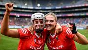 11 August 2024; Cork players Olivia McAllen, left, and Aisling Egan celebrate after their side's victory in the All-Ireland Premier Intermediate Camogie Championship final between Cork and Kilkenny at Croke Park in Dublin. Photo by Piaras Ó Mídheach/Sportsfile