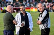 12 August 2024; Referees Cyril Farrell, left, and Dickie Murphy, right, with former boxer Bernard Dunne acting as umpire during the Hurling for Cancer Research 2024 charity match at Netwatch Cullen Park in Carlow. Photo by Piaras Ó Mídheach/Sportsfile