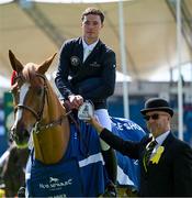 14 August 2024; Francis Derwin of Ireland on Parvati Aeg is presented with the prize after winning the Speed Stakes during the Dublin Horse Show 2024 at the RDS in Dublin. Photo by Shauna Clinton/Sportsfile