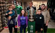 18 August 2024; In attendance are, from left, Shane Roche holding Alex Roche, Ella Power, Aaron O'Sullivan and Stephen Roche, from Tralee, with Kerry FC goalkeeper Antonio Tuta, behind, at the Sports Direct Men’s FAI Cup Trophy Tour at Sports Direct, Tralee, ahead of the Sports Direct Men’s FAI Cup Third Round clash between Kerry and Bohemians at Mounthawk Park in Tralee, Kerry. Photo by Piaras Ó Mídheach/Sportsfile