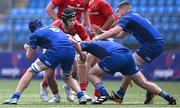 18 August 2024; Zach Piper of Munster in action against Leinster players, from left, Josh Mooney, Connor Canniffe and Lee Fitzpatrick during the U18 School's Interprovincial Round Two match between Leinster and Munster at Energia Park in Dublin. Photo by Shauna Clinton/Sportsfile