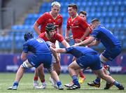 18 August 2024; Zach Piper of Munster in action against Leinster players, from left, Josh Mooney, Connor Canniffe and Lee Fitzpatrick during the U18 School's Interprovincial Round Two match between Leinster and Munster at Energia Park in Dublin. Photo by Shauna Clinton/Sportsfile