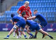 18 August 2024; Zach Piper of Munster in action against Leinster players, from left, Josh Mooney, Connor Canniffe and Lee Fitzpatrick during the U18 School's Interprovincial Round Two match between Leinster and Munster at Energia Park in Dublin. Photo by Shauna Clinton/Sportsfile