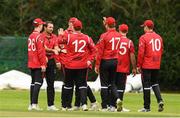 22 August 2024; Liam McCarthy of Munster Reds is congratulated by his team-mates after taking the wicket of Paul Stirling of Northern Knights during the Cricket Ireland Inter-Provincial Cup match between Munster Reds and Northern Knights at The Mardyke in Cork. Photo by Matt Browne/Sportsfile