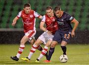 22 August 2024; Deniz Türüç of Basaksehir in action against Kian Leavy, left, and Anto Breslin of St Patrick's Athletic during the UEFA Conference League play-off first leg match between St Patrick's Athletic and Istanbul Basaksehir at Tallaght Stadium in Dublin. Photo by Stephen McCarthy/Sportsfile