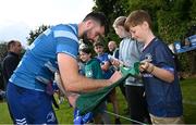 23 August 2024; Harry Byrne signs his autograph for supporters after a Leinster Rugby squad open training session at New Ross RFC in Wexford. Photo by Seb Daly/Sportsfile