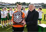 24 August 2024; Cabinteely captain Niamh Haskins is presented with the trophy by FAI president Paul Cooke after the FAI Women’s Amateur Shield Final match between Cabinteely and Dungarvan United at Travers Insurances Park in Arklow, Wicklow. Photo by Seb Daly/Sportsfile