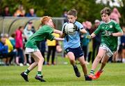 25 August 2024; Shay McCarthy of Cahersiveen, Kerry, in action against Kieran Cleary and Adam McCormack, right, of Kilbride, Roscommon, in Gaelic Football U10 & O7 Boys/Girls/Mixed during the Cairn Community Games National Outdoor Teams Finals at SETU Pitches and Running Track in Carlow. Photo by Piaras Ó Mídheach/Sportsfile