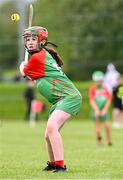 25 August 2024; Shannan Hillard of Inniskeen, Monaghan, in action against Clarecastle-Ballyea, Clare, in the Camogie U14 & O10 Girls during the Cairn Community Games National Outdoor Teams Finals at SETU Pitches and Running Track in Carlow. Photo by Piaras Ó Mídheach/Sportsfile