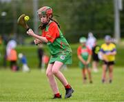 25 August 2024; Shannan Hillard of Inniskeen, Monaghan, in action against Clarecastle-Ballyea, Clare, in the Camogie U14 & O10 Girls during the Cairn Community Games National Outdoor Teams Finals at SETU Pitches and Running Track in Carlow. Photo by Piaras Ó Mídheach/Sportsfile